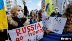 Ukrainians residing in Japan hold placards and flags during a protest rally denouncing on Russia over its actions in Ukraine, near Russian embassy in Tokyo, Japan February 23, 2022.
