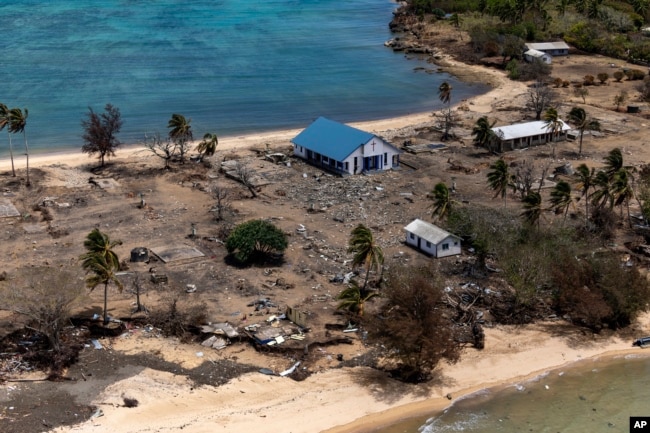 FILE - In this photo provided by the Australian Defence Force, debris from damaged building and trees are strewn around on Atata Island in Tonga, on Jan. 28, 2022, following the eruption of an underwater volcano and subsequent tsunami.