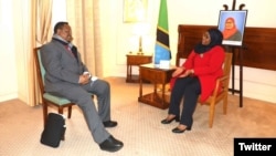 Tanzanian President Samia Suluhu Hassan, right, meets with opposition leader Tundu Lissu in Brussels, Belgium, Feb. 16, 2022, in this photo posted on Twitter by Tanzania's State House @ikulumawasliano.