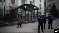 Ukrainian police officers stand guard in front of the Russian Embassy in Kyiv, Feb. 23, 2022.