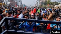 Protesters try to break through a barricade during a protest against the $500 million U.S infrastructure grant under the Millennium Challenge Corporation (MCC) near the parliament in Kathmandu, Nepal, Feb. 18, 2022.