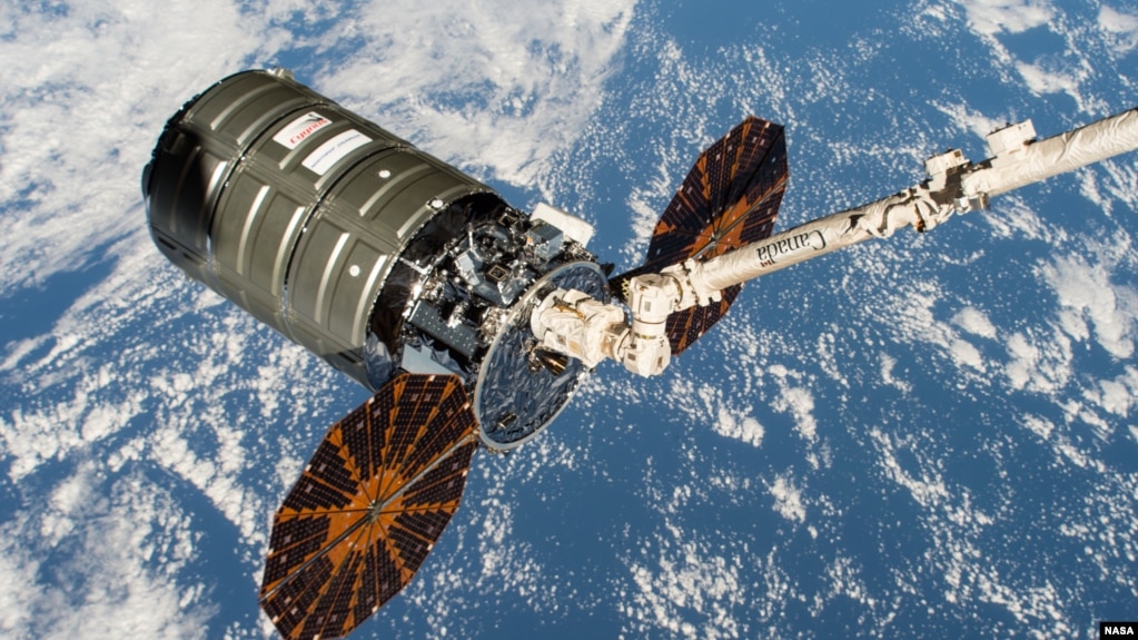 This file photo shows a Northrop Grumman Cygnus spacecraft in the grip of the International Space Station's Canadarm2 robotic arm. (Photo Credit: NASA)