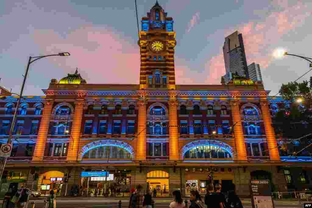 This image shows Flinders Street Station as it is lit in yellow and blue in Melbourne, Australia, as public buildings lit up in the national colors of Ukraine as a show of support.
