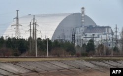 FILE - A giant protective dome built over the destroyed fourth reactor of the Chernobyl Nuclear Power Plant is seen April 13, 2021.