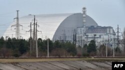 FILE - A giant protective dome built over the destroyed fourth reactor of the Chernobyl Nuclear Power Plant is seen April 13, 2021.