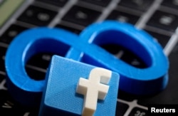 FILE - 3D-printed images of logos of Facebook parent Meta Platforms and of Facebook are seen on a laptop keyboard in this illustration taken on November 2, 2021. (REUTERS/Dado Ruvic/Illustration)