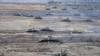 Tanks move during the Union Courage-2022 Russia-Belarus military drills at the Obuz-Lesnovsky training ground in Belarus, Feb. 19, 2022. 