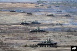 Tanks move during the Union Courage-2022 Russia-Belarus military drills at the Obuz-Lesnovsky training ground in Belarus, Feb. 19, 2022.