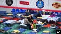 Displaced civilians from the Donetsk and Luhansk regions rest in a sport hall in Taganrog, Russia, Feb.  21, 2022.