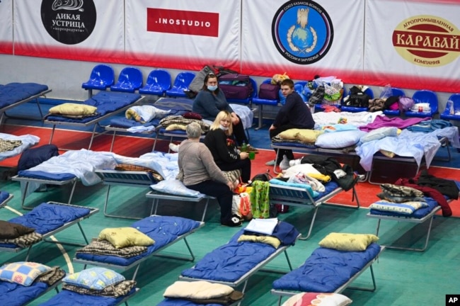 Displaced civilians from the Donetsk and Luhansk regions rest in a sport hall in Taganrog, Russia, Feb. 21, 2022.