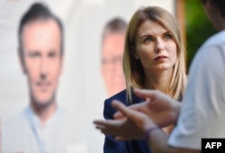 FILE - Lesya Vasylenko, lawyer, human rights activist and candidate of Ukrainian party Golos (Voice), talks with voters during a campaign meeting, ahead of parliamentary election, in Kyiv, July 16, 2019.