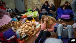 People rest in the Kyiv subway, using it as a bomb shelter in Kyiv, Ukraine, Feb. 24, 2022. 