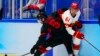 China's Wei Ruike (Ethan Werek) (61) is checked by Canada's Morgan Ellis (5) during a men's qualification round hockey game at the 2022 Winter Olympics, Feb. 15, 2022, in Beijing.
