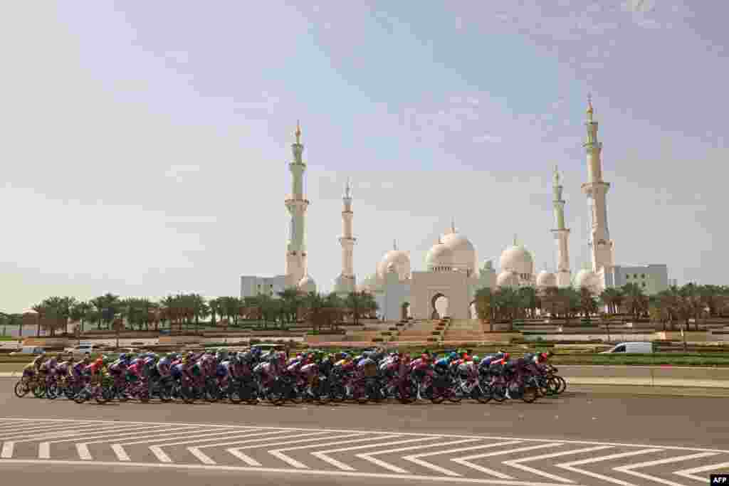 The peloton rides across the Sheikh Zayed Grand Mosque during the start of the second stage of the UAE cycling tour from al-Hudayriat island to Abu Dhabi Breakwater.