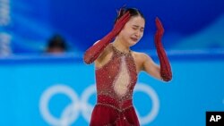 Zhu Yi, of China, reacts in the women's team free skate program during the figure skating competition at the 2022 Winter Olympics, Feb. 7, 2022, in Beijing.