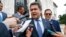 FILE - Honduran President Juan Orlando Hernandez answers questions from the media, Aug. 13, 2019, in Washington.