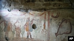 A fresco, or wall painting, is seen inside the kitchen of a house at Pompeii, Feb. 15, 2022. (AP Photo/Gregorio Borgia)