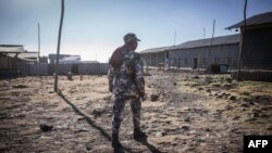 FILE - A police officer walks inside a prison in Mehal Meda, Ethiopia, Dec. 06, 2021. Thousands of Ethiopian civilians reportedly remain detained under an emergency law, without due process.