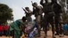 A woman lays flowers at the base of a monument to Central African soldiers and Russian armed men, in Bangui, Central African Republic, Feb. 23, 2022.