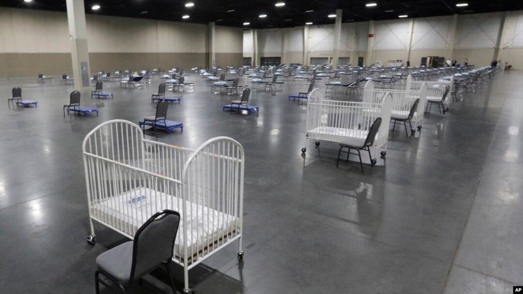 FILE - Cots and cribs are arranged at the Mountain America Expo Center in Sandy, Utah, on April 6, 2020, as an alternate care site or for hospital overflow amid the COVID-19 pandemic.