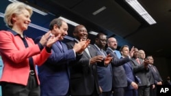 From left, European Commission President Ursula von der Leyen, Presidents of Egypt, South Africa, Senegal, European Council President, French, Kenyan and Tunisian Presidents, WHO Director General pose on the podium at an EU Africa summit in Brussels, Feb. 18, 2022.