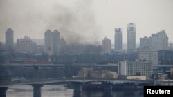 Smoke rises from the territory of the Ukrainian Defense Ministry's unit, after Russian President Vladimir Putin authorized a military operation in eastern Ukraine, in Kyiv, Feb. 24, 2022. 