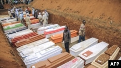 Civilians and Red Cross volunteers are seen at the Feb. 4, 2022, burial of 62 displaced people who were massacred on the night of Feb. 1, 2022, at the Plaine Savo IDP camp near Bule, Ituri province, northeastern Democratic Republic of Congo. 