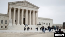 A visiting school group walks along the plaza at the U.S. Supreme Court on Capitol Hill in Washington, U.S., Feb. 22, 2022.