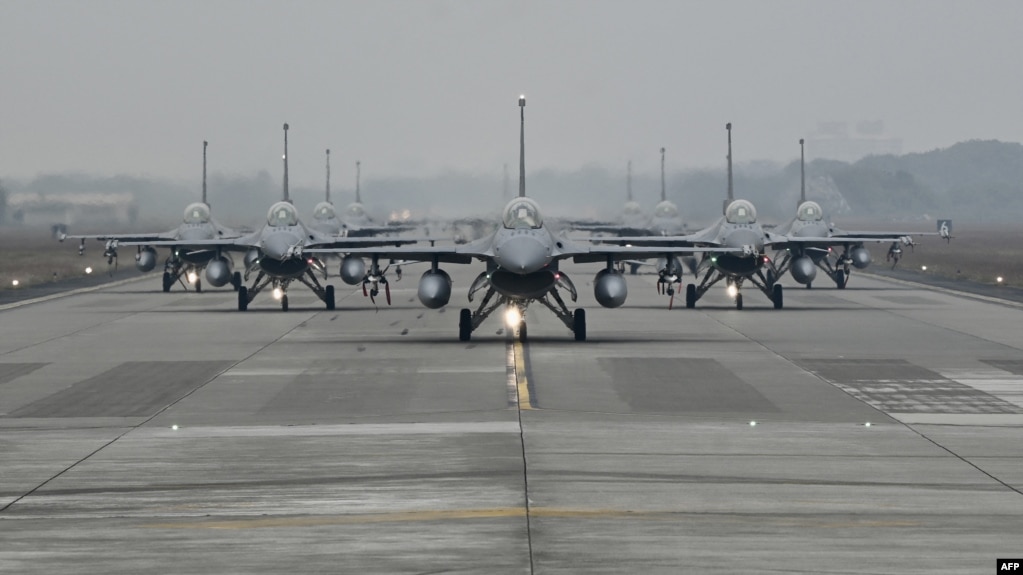 FILE - US-made F-16V fighters taxi on the runway at an air force base in Chiayi, southern Taiwan, Jan. 5, 2022. 