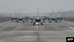 FILE - US-made F-16V fighters taxi on the runway at an air force base in Chiayi, southern Taiwan, Jan. 5, 2022. 