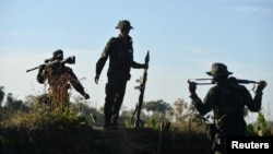 FILE - Members of the People's Defense Forces (PDF) who have taken up arms against Myanmar's military junta are seen on a front line in Kawkareik, Myanmar, Dec. 31, 2021.