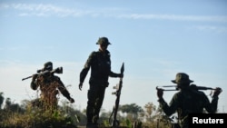 FILE - Members of the People's Defense Forces (PDF) who have taken up arms against Myanmar's military junta are seen on a front line in Kawkareik, Myanmar, December 31, 2021.