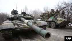 Ukrainian servicemen get ready to respond to an attack in Ukraine's Lugansk region on Feb. 24, 2022.