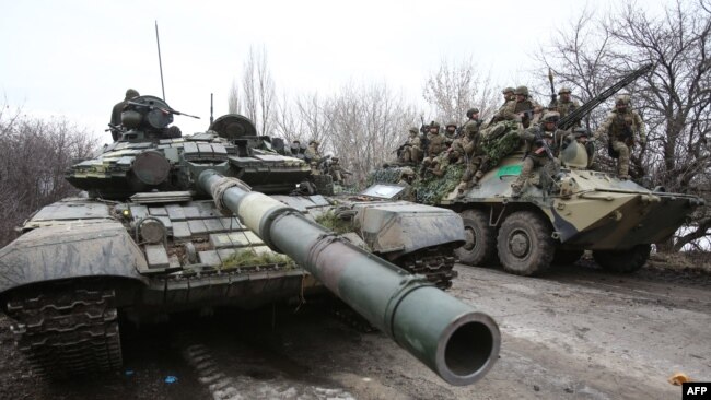 Ukrainian servicemen get ready to respond to an attack in Ukraine's Lugansk region on Feb. 24, 2022.