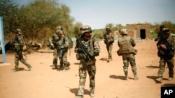 FILE - French soldiers secure the area at the entrance of Gao, northern Mali, on Feb. 10, 2013.