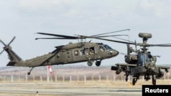 US military helicopters lift off from Traian Vuia International Airport of Timisoara city, Romania, Feb. 24, 2022.