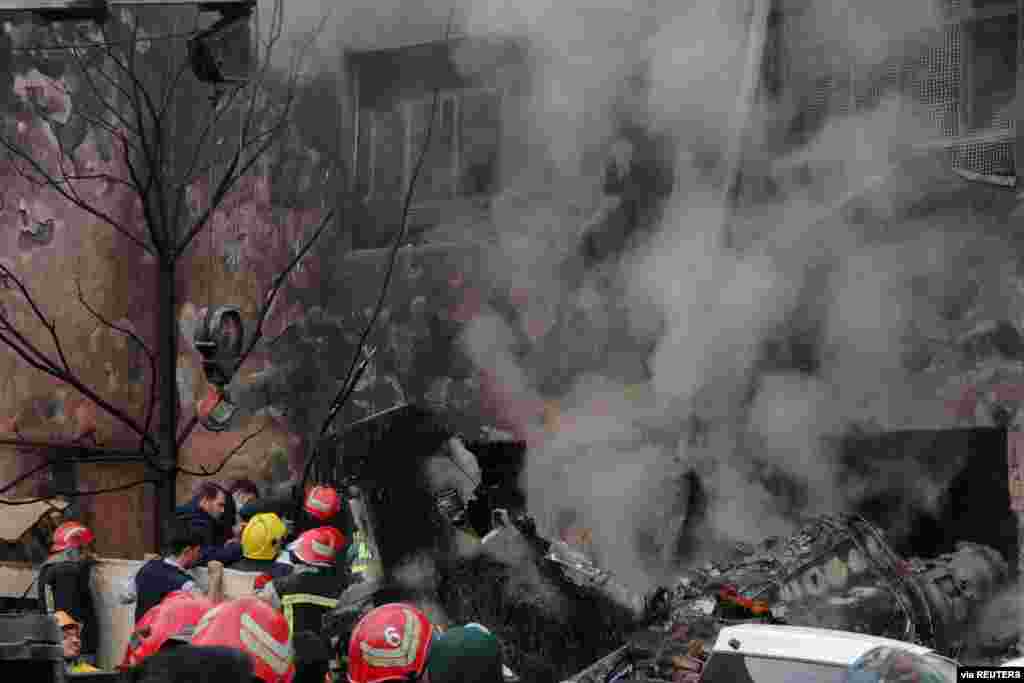 First responders work amid debris from the crashed fighter jet, in Tabriz, Iran. (Credit: Mehr News/WANA)