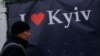 A man walks by an ''I love Kyiv'' banner in downtown Kyiv, Feb. 17, 2022.