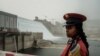 A member of the Republican March Band poses for photo before at the ceremony for the inaugural production of energy at the Grand Ethiopian Renaissance Dam (GERD) in Guba, Ethiopia, Feb. 20, 2022. 