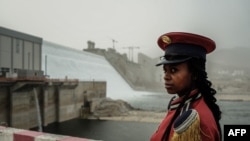 A member of the Republican March Band poses for photo before at the ceremony for the inaugural production of energy at the Grand Ethiopian Renaissance Dam (GERD) in Guba, Ethiopia, Feb. 20, 2022. 