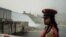 A member of the Republican March Band poses for photo before at the ceremony for the inaugural production of energy at the Grand Ethiopian Renaissance Dam (GERD) in Guba, Ethiopia, Feb. 20, 2022. 