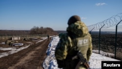Ukrainian frontier guards patrol an area along the Ukrainian-Russian border in the Kharkiv region, Ukraine on Feb. 23, 2022.