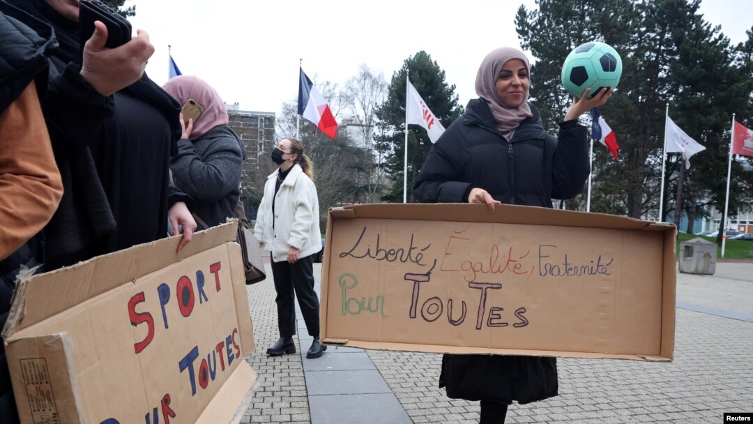 Pendukung tim sepak bola perempuan "Les Hijabeuses" berunjuk rasa di depan balai kota di Lille, Prancis, 16 Februari 2022. Slogan-slogan itu berbunyi "Olahraga untuk semua" dan "Kebebasan, Kesetaraan, Persaudaraan untuk semua". (REUTERS/Pascal Rossignol)