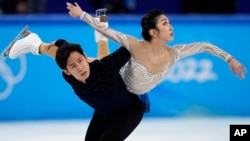 Sui Wenjing and Han Cong, of China, compete in the pairs free skate program during the figure skating competition at the 2022 Winter Olympics, Feb. 19, 2022, in Beijing.