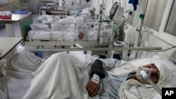 An Afghan patient infected with COVID-19 lies on a bed in the intensive care unit of the Afghan Japan Communicable Disease Hospital, in Kabul, Afghanistan, Feb. 7, 2022. 