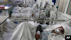 An Afghan patient infected with COVID-19 lies on a bed in the intensive care unit of the Afghan Japan Communicable Disease Hospital, in Kabul, Afghanistan, Feb. 7, 2022.