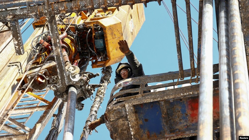 FILE - A drilling crew member works at an oil rig in the Yarakta Oil Field, owned by Irkutsk Oil Company (INK), in Irkutsk region, Russia, March 11, 2019.