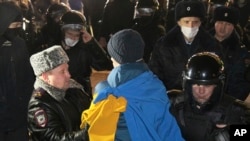 Police officers detain a protester in Nizhny Novgorod, Russia, Feb. 24, 2022. Hundreds of people gathered in the center of Moscow, St. Petersburg, Nizhny Novgorod and other Russian cities on Thursday, protesting against Russia's attack on Ukraine.