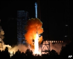 In this photo released by China's Xinhua News Agency, the the unmanned Chang’e 5-T1 spacecraft is launched atop an advanced Long March 3C rocket from the Xichang Satellite Launch Center in southwest China's Sichuan Province, Friday, Oct. 24, 2014. (AP Pho