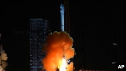 In this photo released by China's Xinhua News Agency, the the unmanned Chang’e 5-T1 spacecraft is launched atop an advanced Long March 3C rocket from the Xichang Satellite Launch Center in southwest China's Sichuan Province, Friday, Oct. 24, 2014. (AP Pho